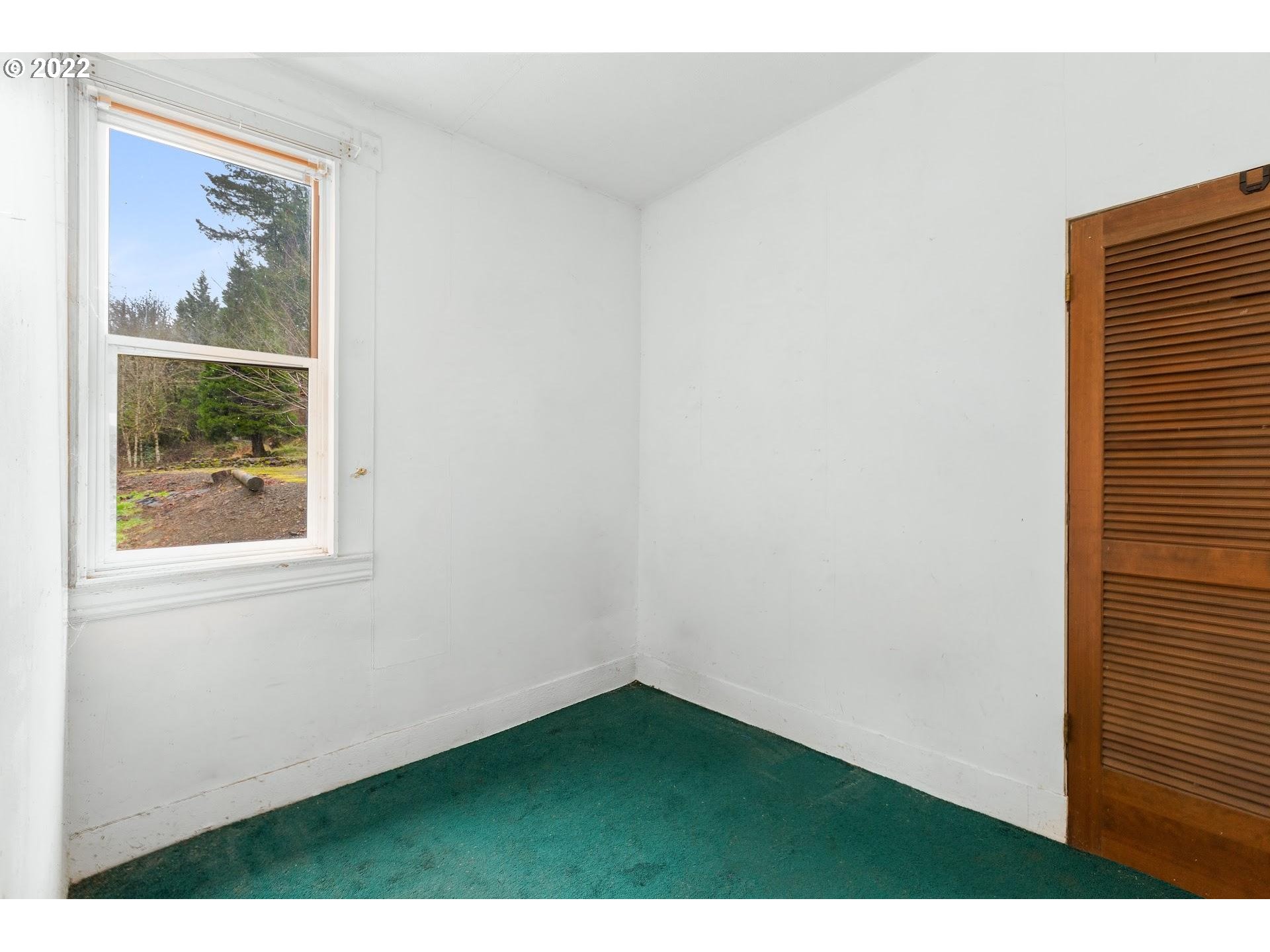 15055 Northwest Cornelius Pass Road Portland, OR 97231 - Photo 6 of 13 a view of an empty room with a window