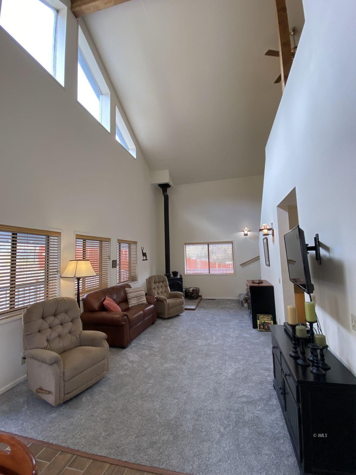 156 Alpine Drive Bishop, CA 93514 - Photo 2 of 17 a living room with furniture a flat screen tv and a large window