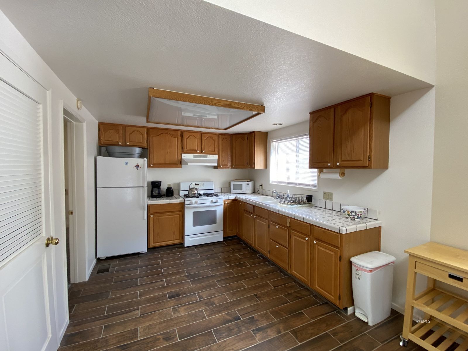 156 Alpine Drive Bishop, CA 93514 - Photo 3 of 17 a kitchen with a sink cabinets stainless steel appliances and a window