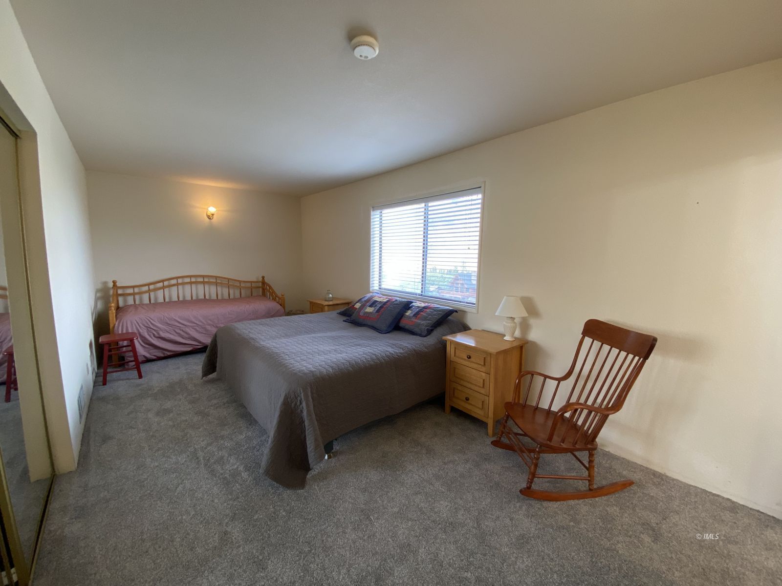 156 Alpine Drive Bishop, CA 93514 - Photo 5 of 17 a spacious bedroom with a bed chair and window