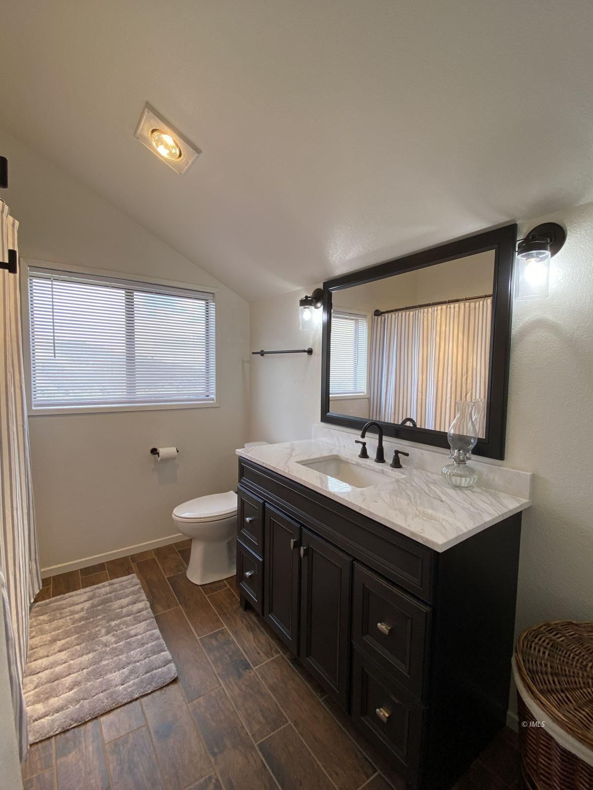 156 Alpine Drive Bishop, CA 93514 - Photo 6 of 17 a bathroom with a granite countertop sink toilet and mirror