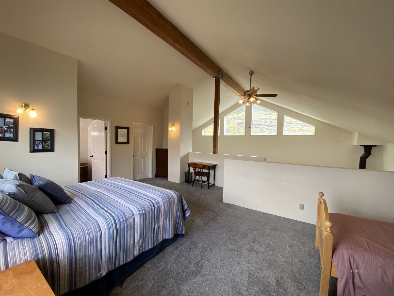 156 Alpine Drive Bishop, CA 93514 - Photo 7 of 17 a spacious bedroom with a bed and a large mirror on the dresser