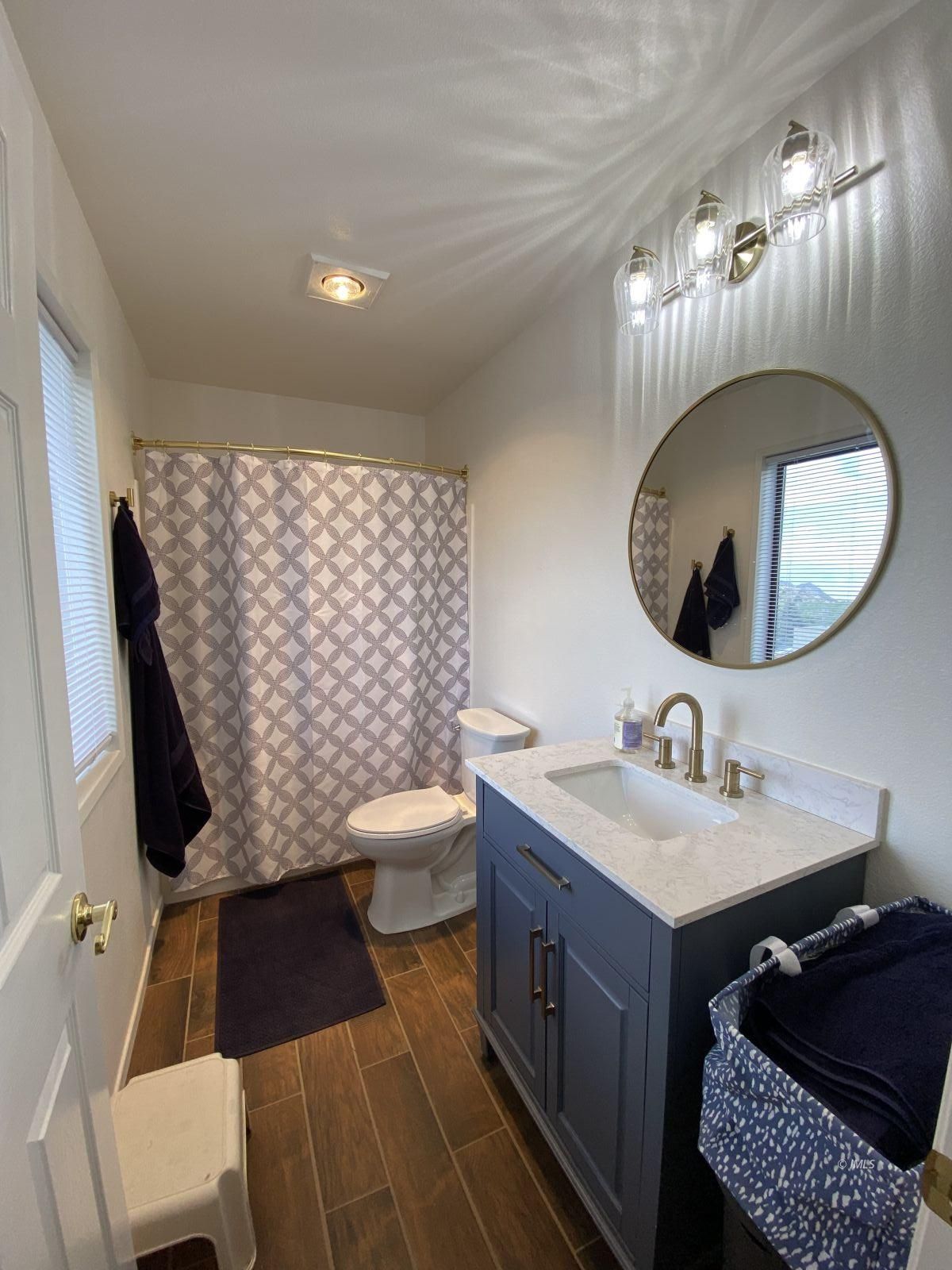156 Alpine Drive Bishop, CA 93514 - Photo 8 of 17 a bathroom with a sink toilet a mirror and vanity