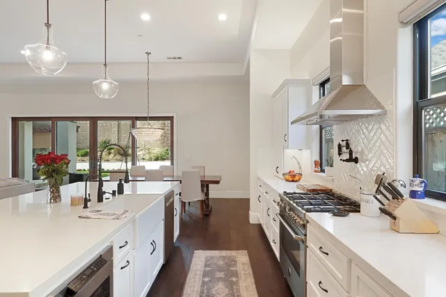 a kitchen with a stove and a large window