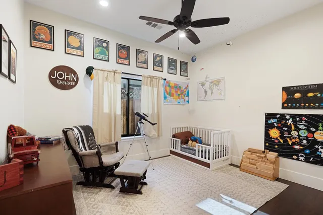 a living room with furniture and ceiling fan