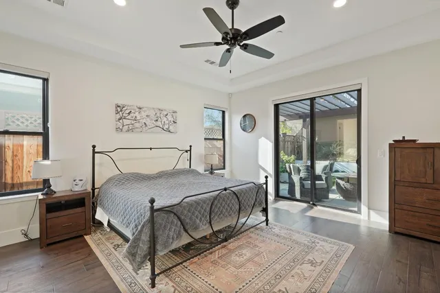 a bedroom with a bed and a large window