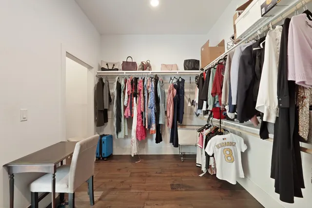 a view of walk in closet with clothes