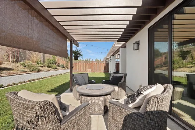 a view of a patio with couches chairs and a fire pit