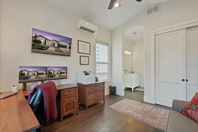 a bedroom with furniture and a wooden floor
