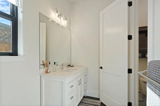 a bathroom with a double vanity sink and mirror