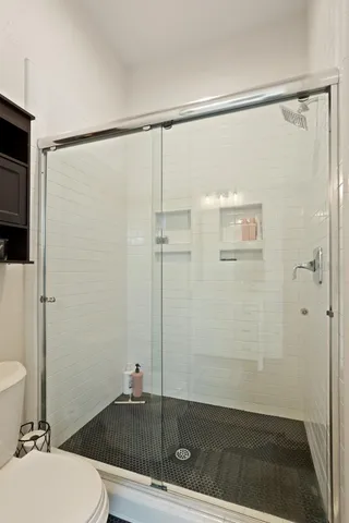 a bathroom with a shower and a toilet