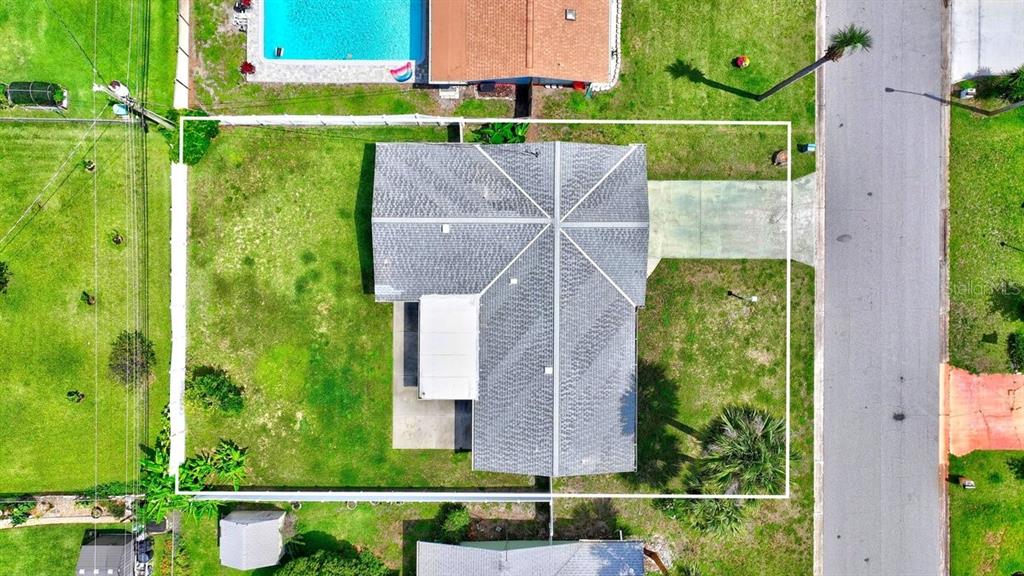 1309 Suwanee Road Daytona Beach, FL 32114 - Photo 28 of 33 an aerial view of a house with a garden and yard
