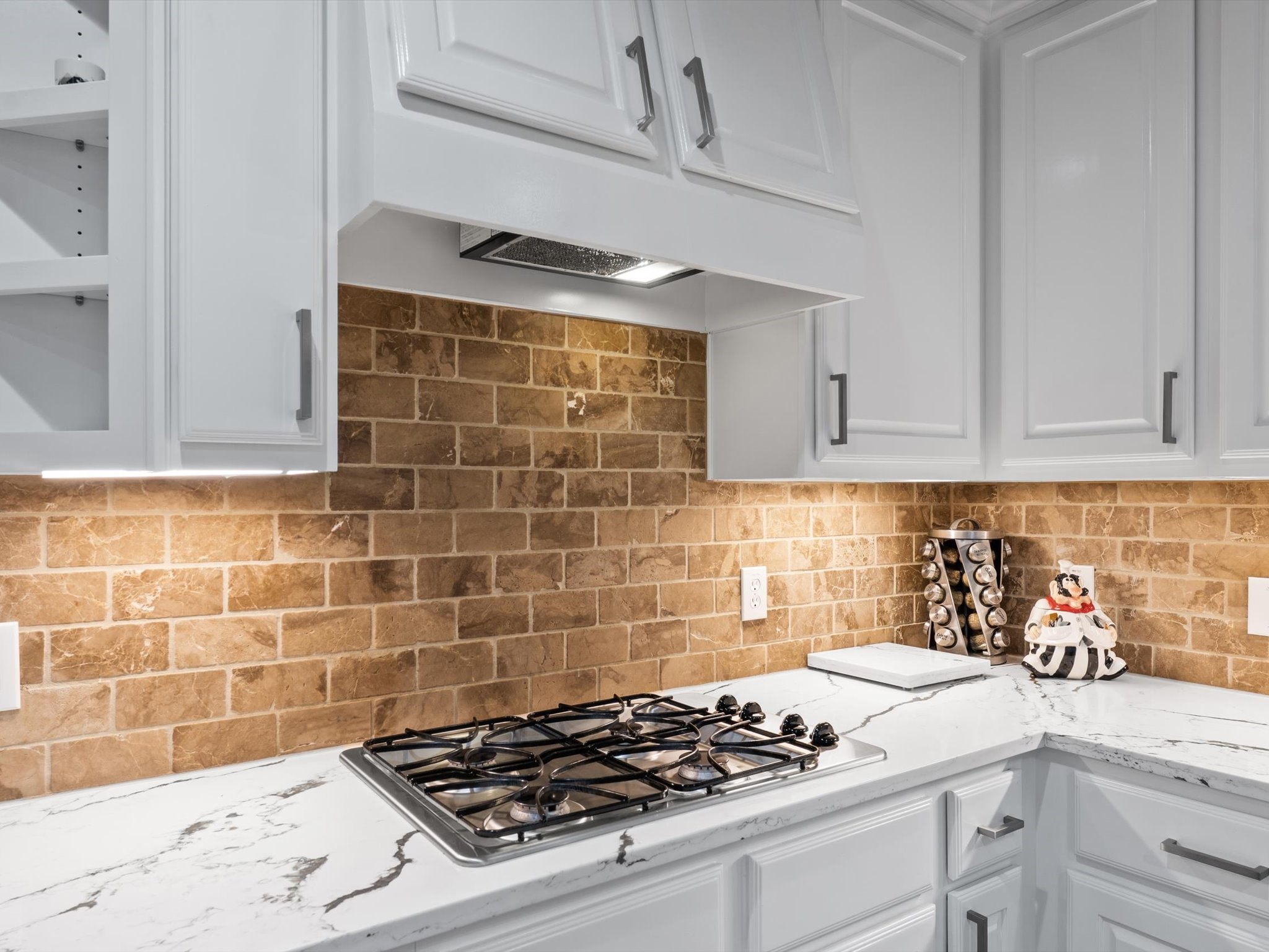 6003 Tarra Firma Drive Spring, TX 77379 - Photo 12 of 43 Sleek built-in gas cooktop paired with a matching ventilation hood. This modern setup offers a clean look and reliable performance for daily meal prep.