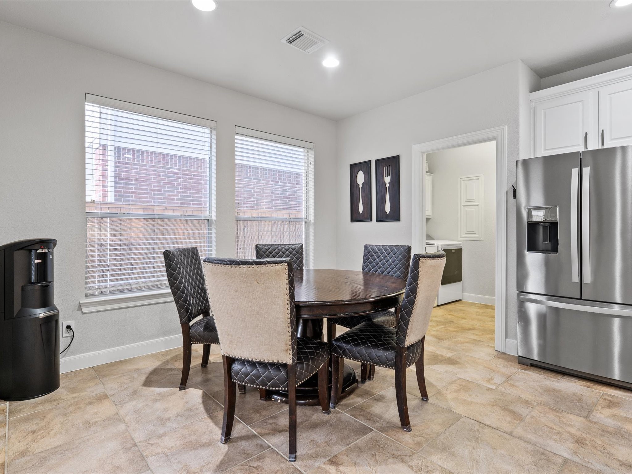 6003 Tarra Firma Drive Spring, TX 77379 - Photo 14 of 43 The sun-drenched breakfast room is perfectly integrated into the kitchen, creating an open-concept morning retreat. It features direct access to the outdoor living area, allowing for a seamless transition from your morning coffee to the poolside patio.