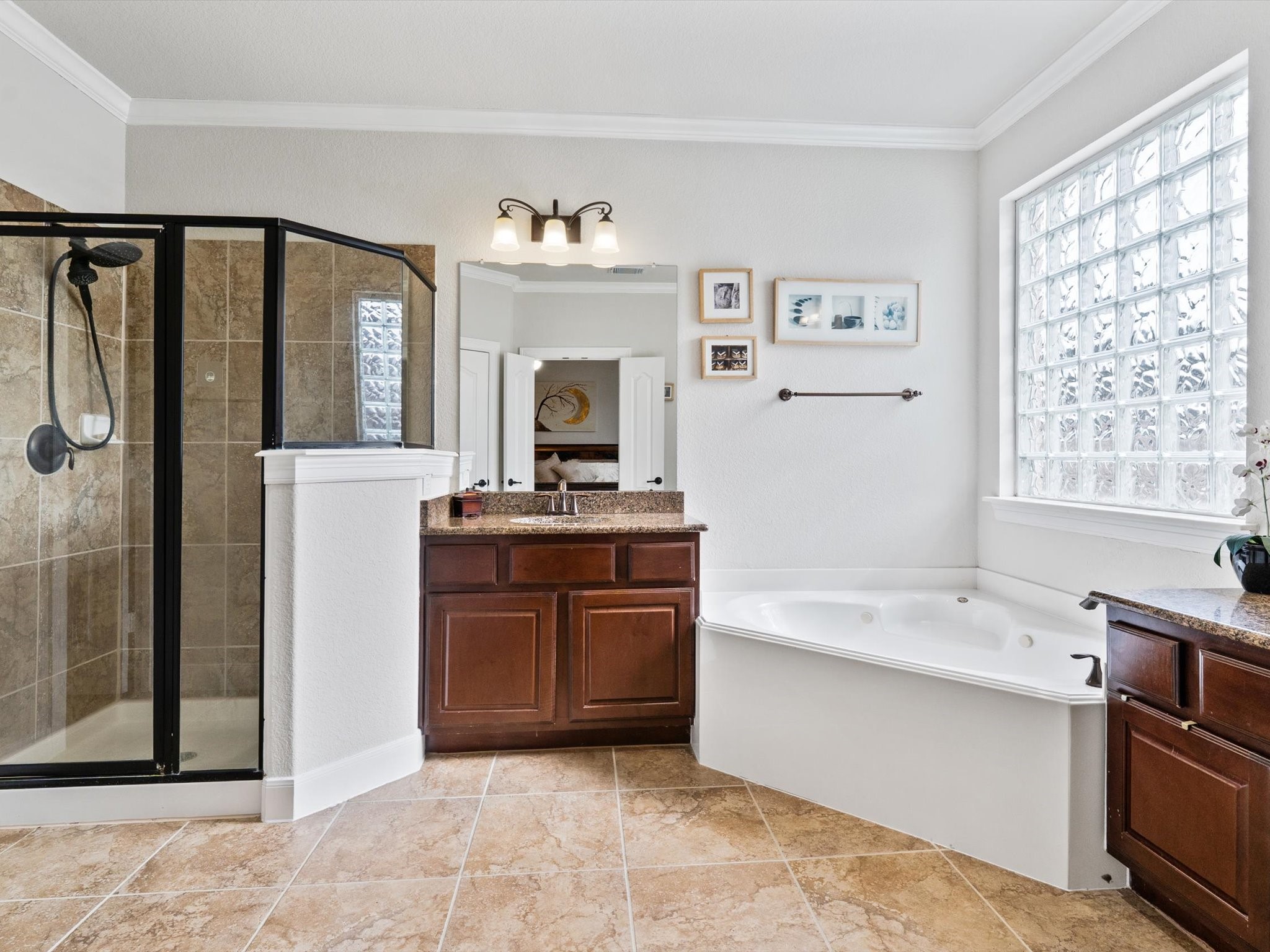 6003 Tarra Firma Drive Spring, TX 77379 - Photo 18 of 43 Spa-like ensuite with dual vanities, a deep soaking tub, a separate glass shower, and a massive walk-in closet.