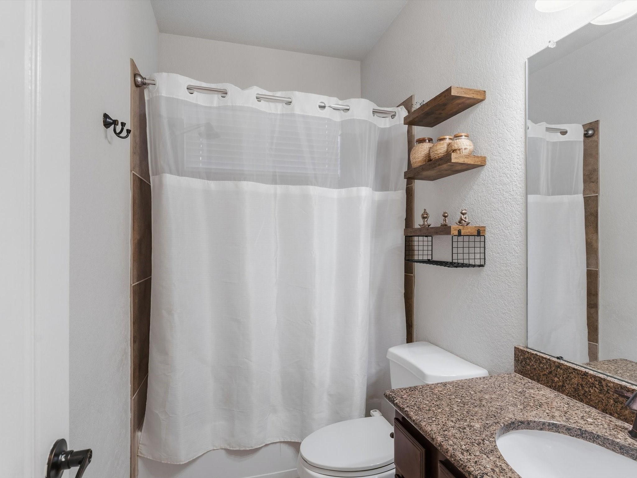 6003 Tarra Firma Drive Spring, TX 77379 - Photo 22 of 43 This secondary full bathroom is perfectly located on the first floor to serve both guests and residents. Featuring high-quality finishes and a full-size shower or tub, it adds an extra layer of versatility to the home's main living level.