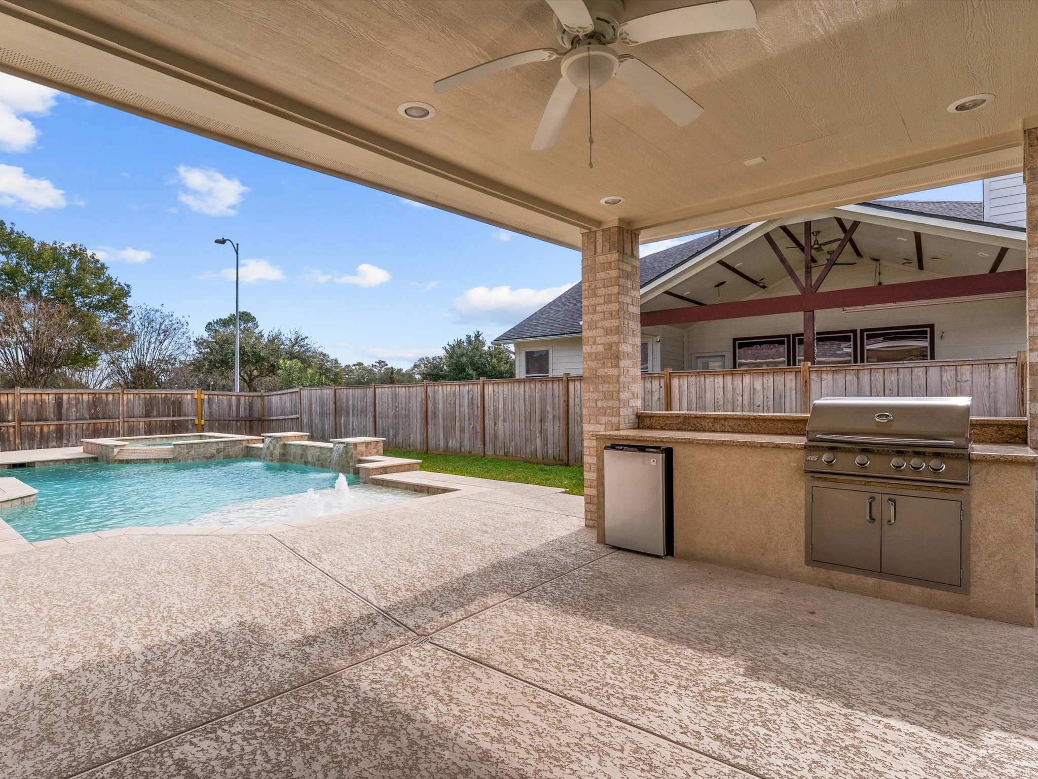 6003 Tarra Firma Drive Spring, TX 77379 - Photo 25 of 43 This professional outdoor setup comes complete with a built-in grill and a convenient refrigerator to keep your drinks cold all summer long. Everything you need for effortless poolside entertaining is right at your fingertips in this incredible backyard retreat.