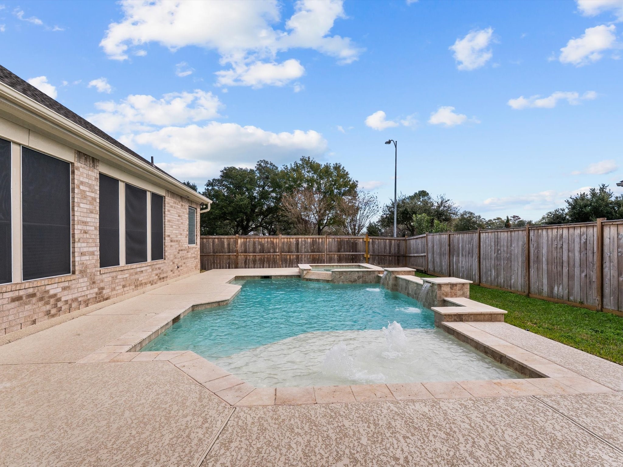 6003 Tarra Firma Drive Spring, TX 77379 - Photo 26 of 43 Your Personal Backyard Resort. Dive into luxury with this stunning in-ground pool featuring a dedicated sun deck for shallow-water lounging. After a long day, you can soak your cares away in the elevated hot tub. This space is perfectly designed for both high-energy summer fun and peaceful evening relaxation.