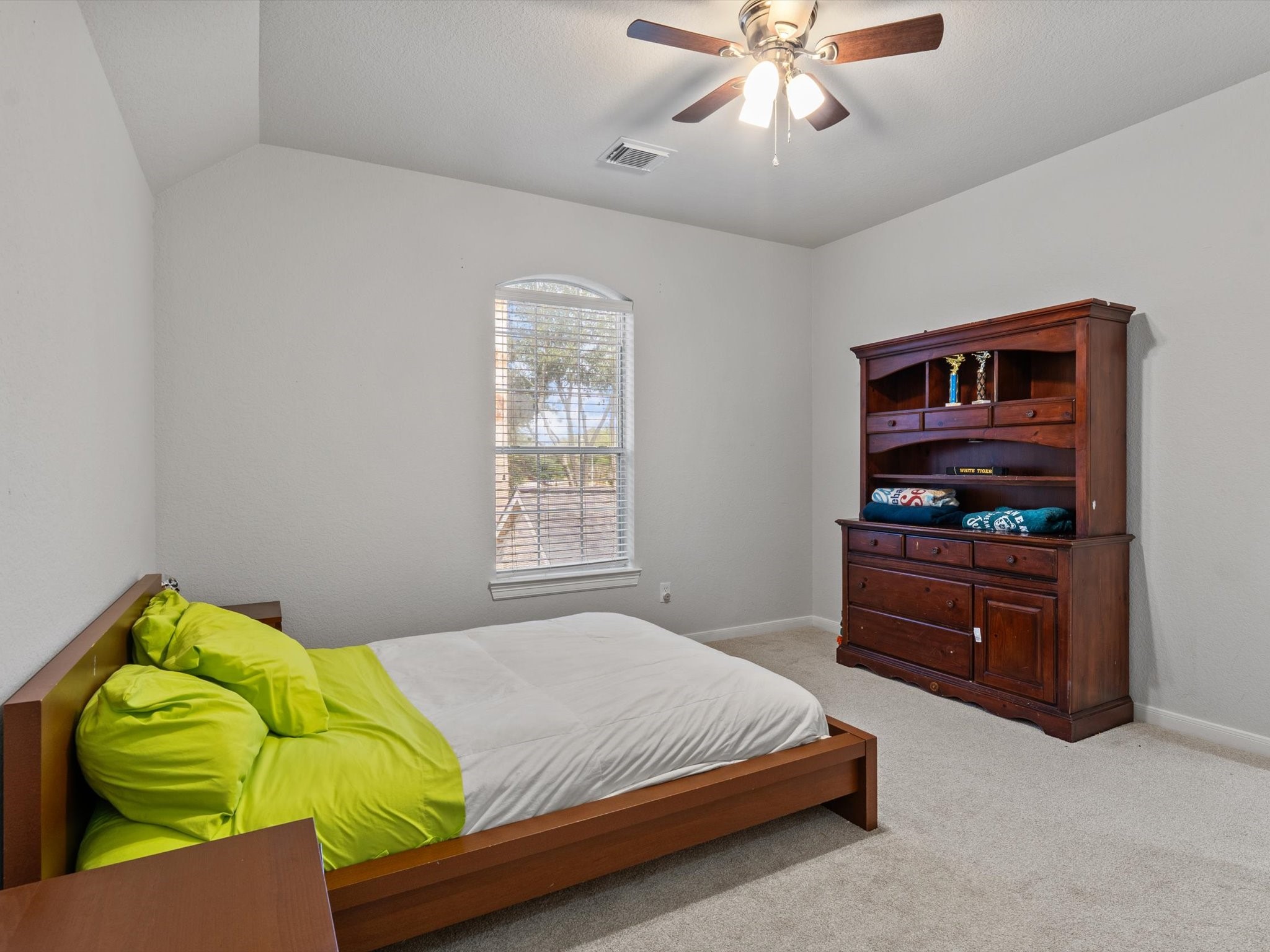 6003 Tarra Firma Drive Spring, TX 77379 - Photo 33 of 43 This is one of three generous bedrooms located on the second floor. Featuring ample closet space and large windows, it serves as a perfect retreat for family members or guests. Each room upstairs is designed with comfort and versatility in mind to ensure everyone has their own private sanctuary.