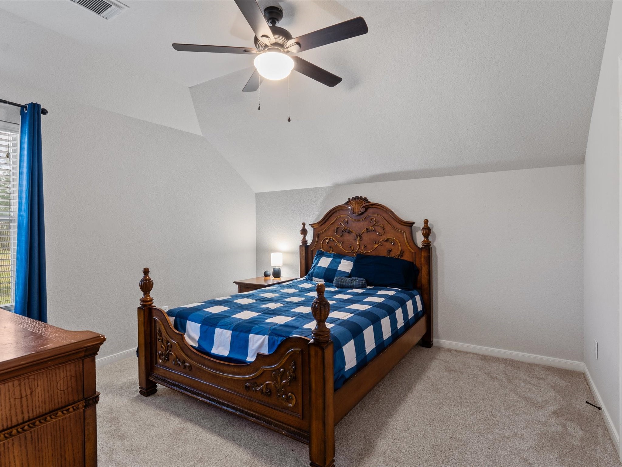 6003 Tarra Firma Drive Spring, TX 77379 - Photo 35 of 43 This is one of three generous bedrooms located on the second floor. Featuring ample closet space and large windows, it serves as a perfect retreat for family members or guests. Each room upstairs is designed with comfort and versatility in mind to ensure everyone has their own private sanctuary.