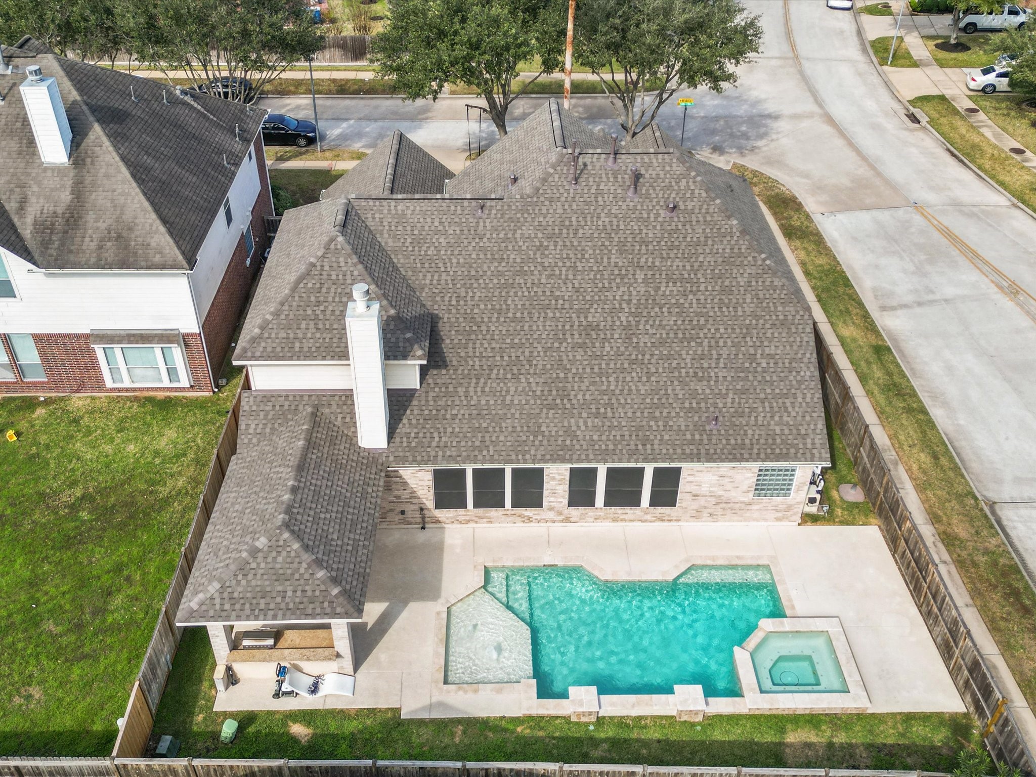 6003 Tarra Firma Drive Spring, TX 77379 - Photo 40 of 43 Take in the full scale of this incredible property with a stunning aerial view. This home features a brand new roof for total peace of mind and an expansive backyard oasis complete with a sparkling pool. Situated on a prime corner lot with walkable sidewalks, this house offers the perfect blend of architectural beauty and a premier location.