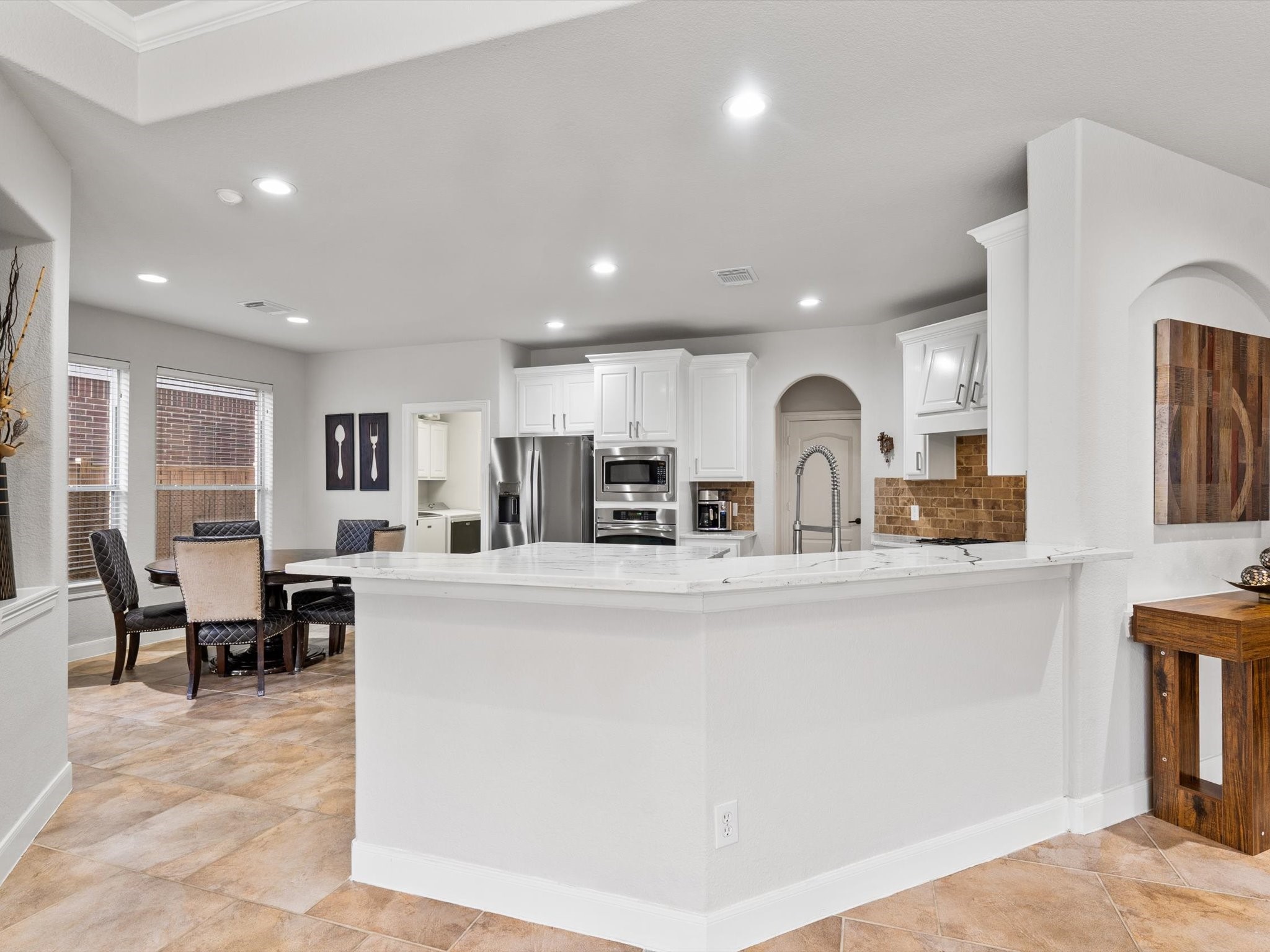 6003 Tarra Firma Drive Spring, TX 77379 - Photo 10 of 43 Experience the ultimate open-concept lifestyle where the living room flows effortlessly into the heart of the home. This expansive "Great Room" layout is designed for the way we live today, offering shared light, clear sightlines, and plenty of space for the whole family to gather without feeling crowded.