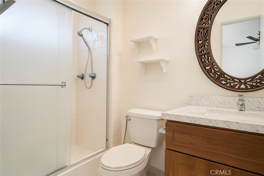18619 Collins Street, Unit F29 Tarzana, CA 91356 - Photo 12 of 29 a bathroom with a sink a toilet and a mirror