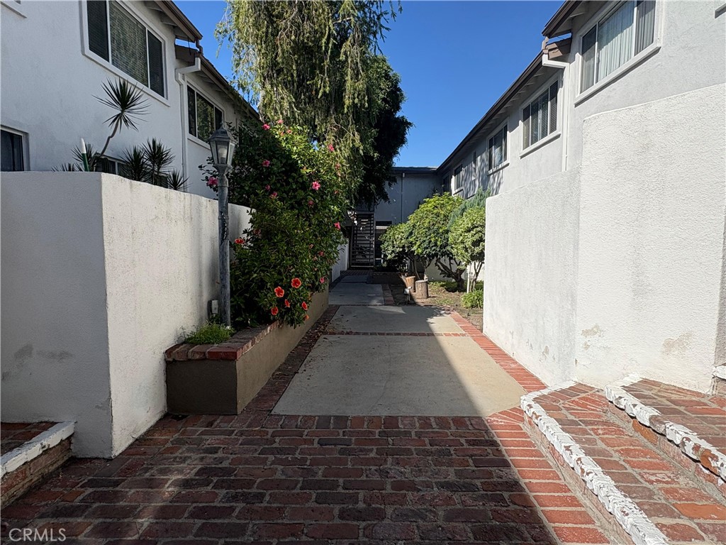 18619 Collins Street, Unit F29 Tarzana, CA 91356 - Photo 16 of 29 a view of a pathway with a house