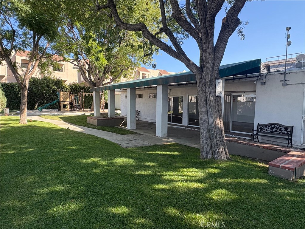 18619 Collins Street, Unit F29 Tarzana, CA 91356 - Photo 24 of 29 a house view with a sitting space and garden