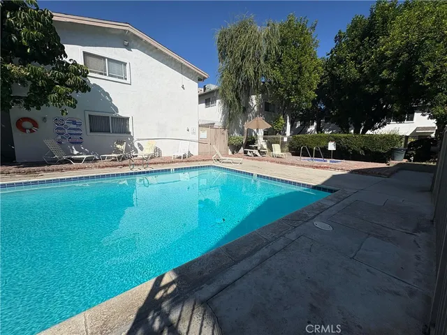 a view of a backyard with swimming pool