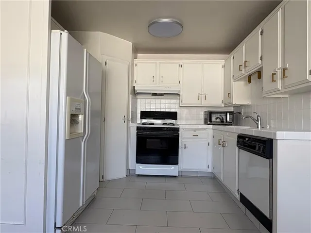 a kitchen with cabinets and stainless steel appliances