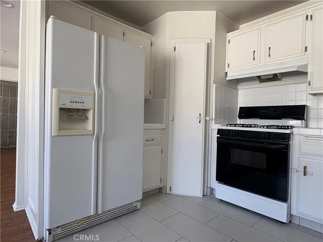 a kitchen with cabinets and stainless steel appliances