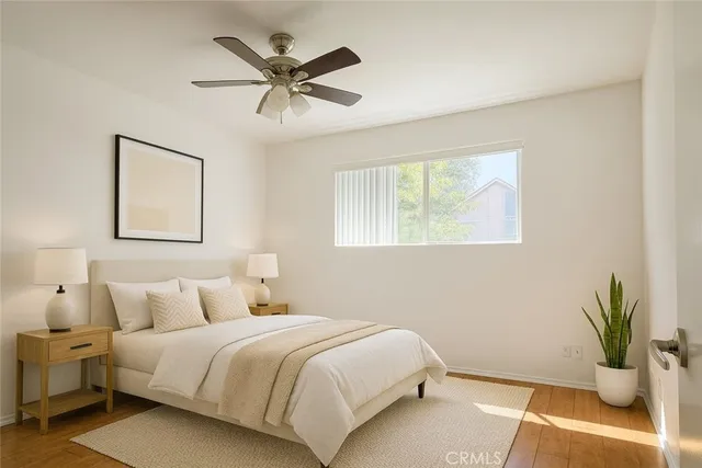 a bedroom with a bed and painting on the wall