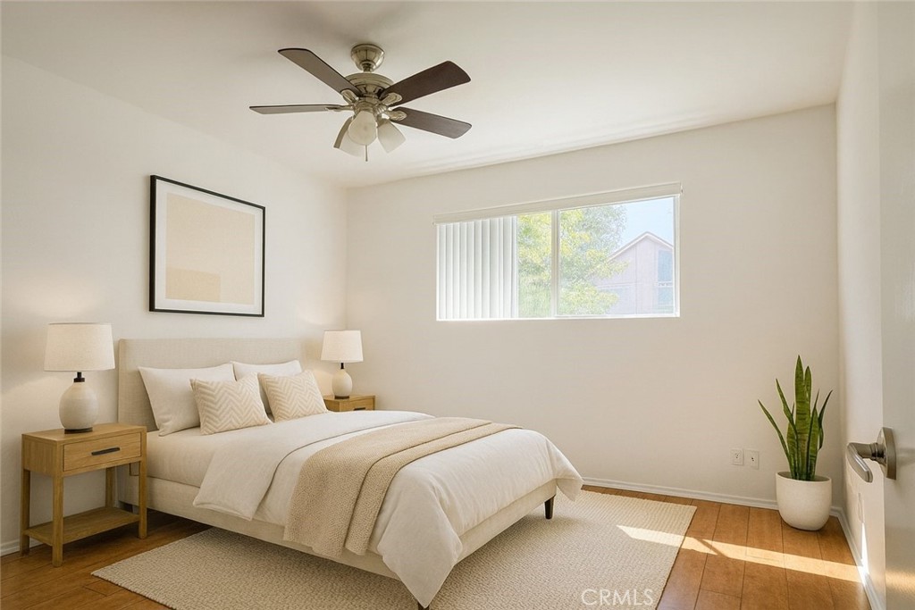 18619 Collins Street, Unit F29 Tarzana, CA 91356 - Photo 9 of 29 a bedroom with a bed and painting on the wall