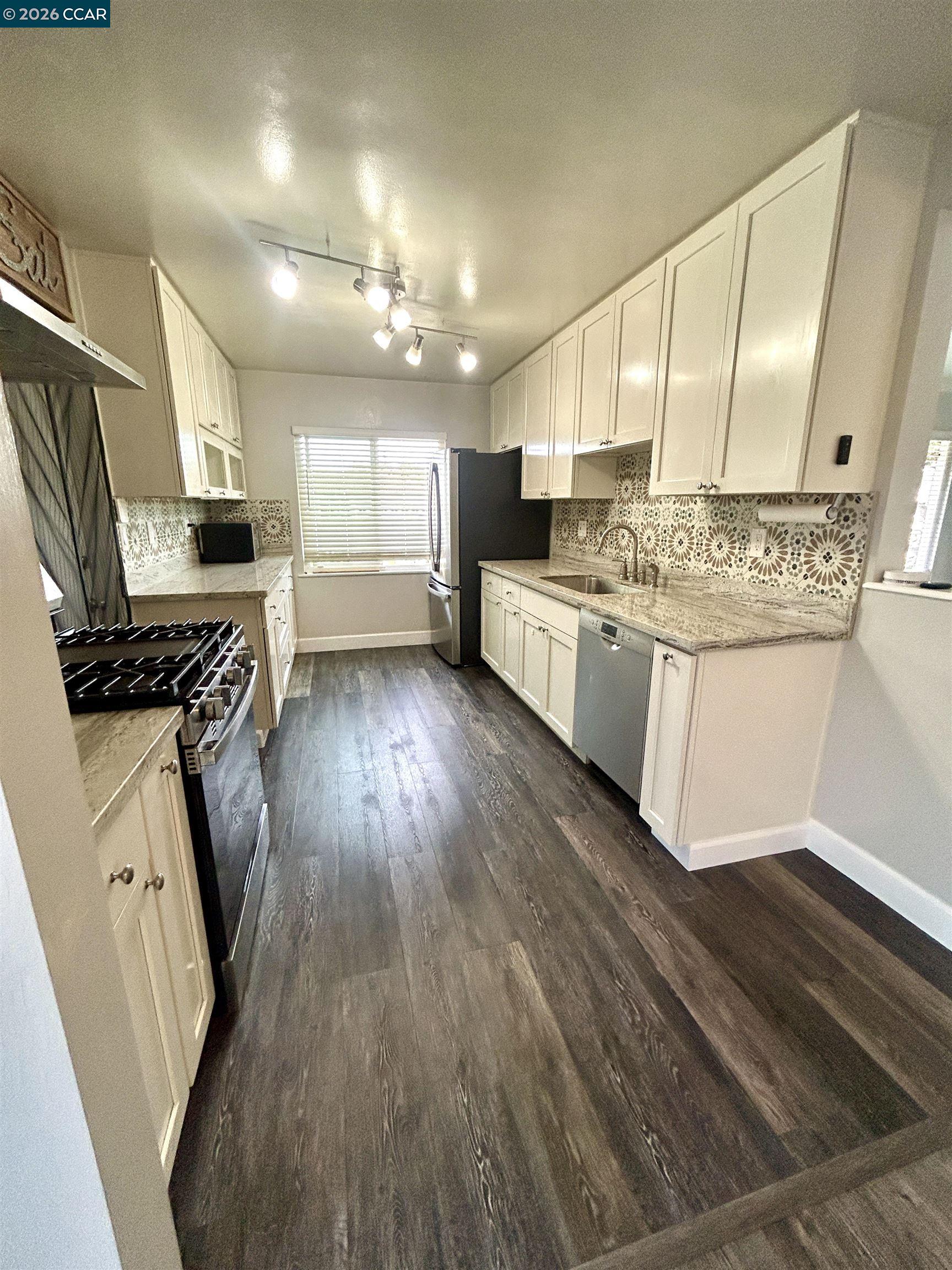 356 Frederic Avenue Hayward, CA 94544 - Photo 4 of 10 a kitchen with stainless steel appliances kitchen island granite countertop a stove a sink and a refrigerator