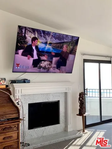 a living room with a fireplace with wooden floor