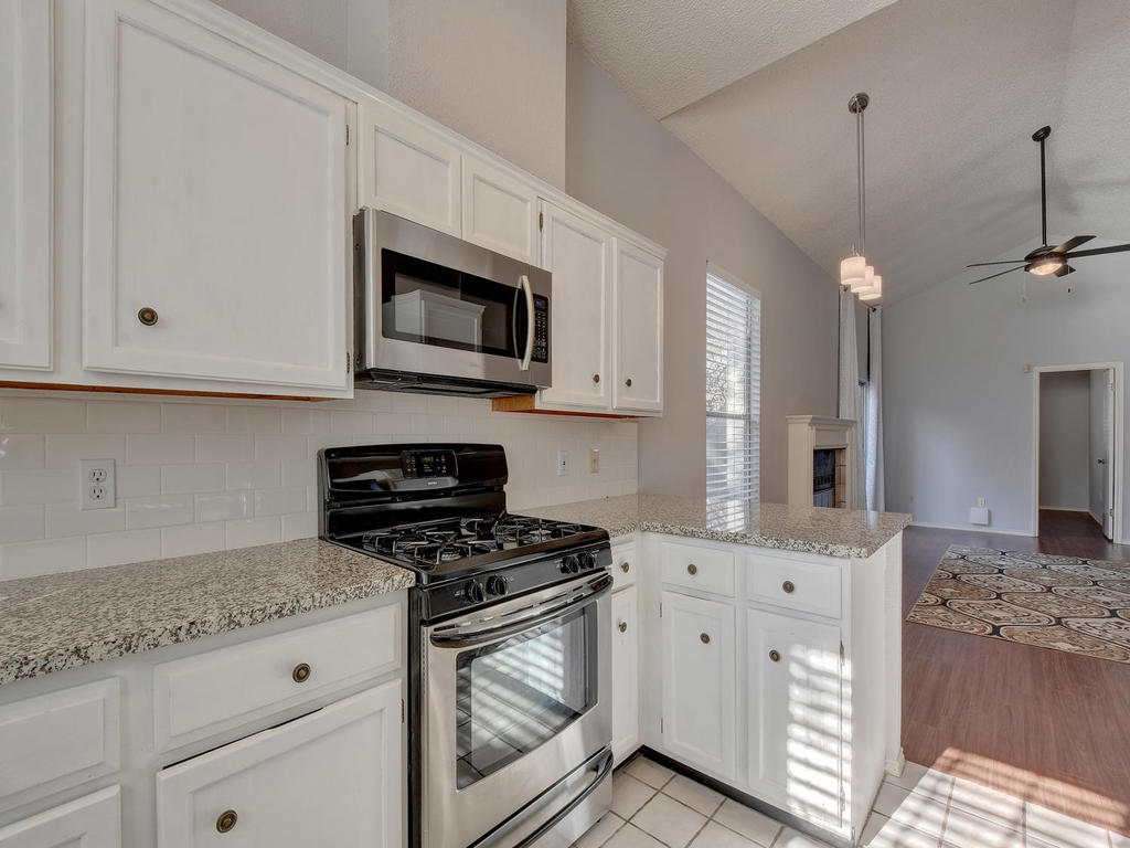 3019 Rochelle Drive Austin, TX 78748 - Photo 21 of 21 a kitchen with granite countertop white cabinets stainless steel appliances and sink