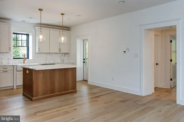 a kitchen with granite countertop a sink and a refrigerator