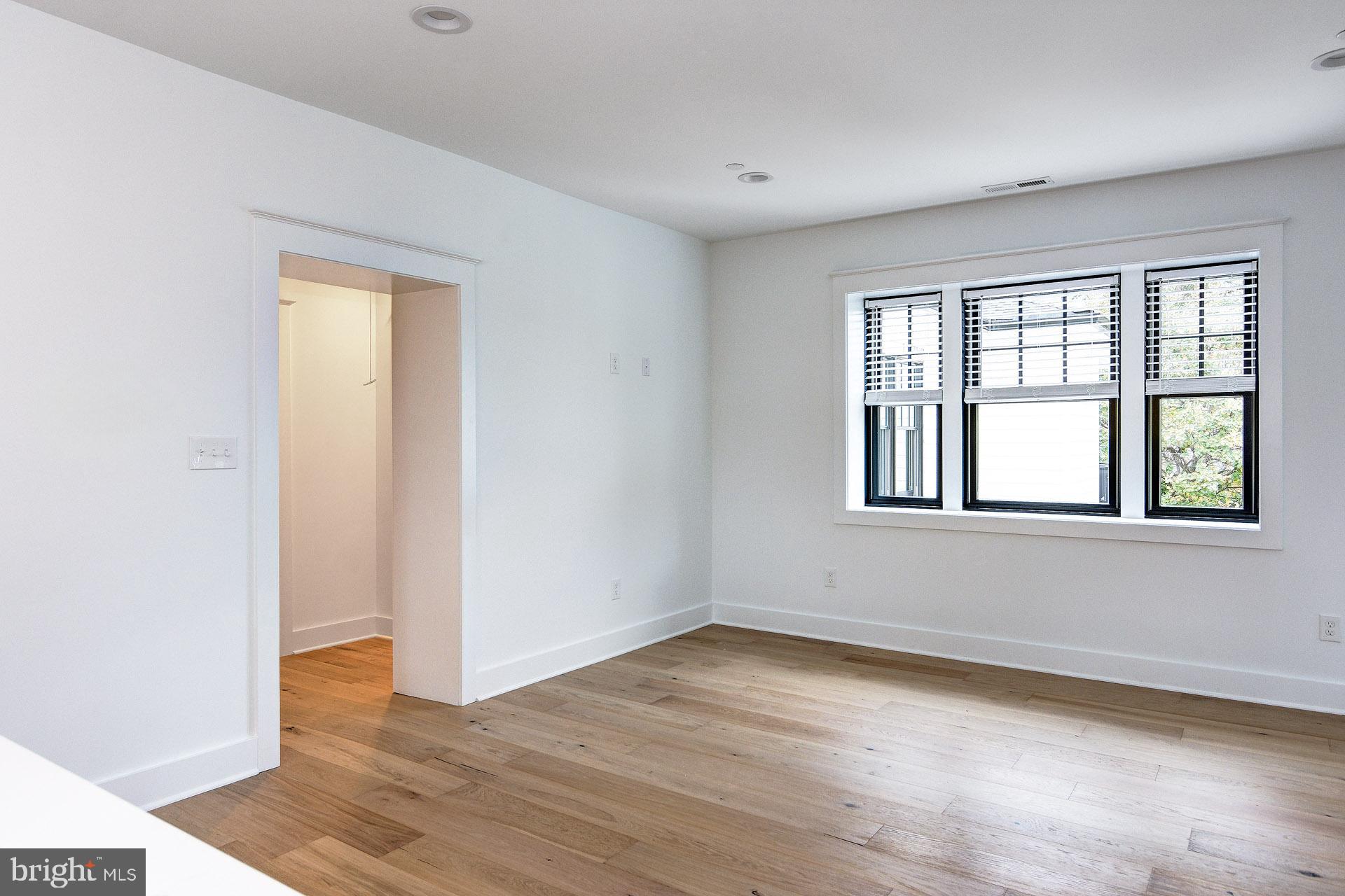 20 East Redman Avenue, Unit D Haddonfield, NJ 08033 - Photo 16 of 43 an empty room with wooden floor and windows
