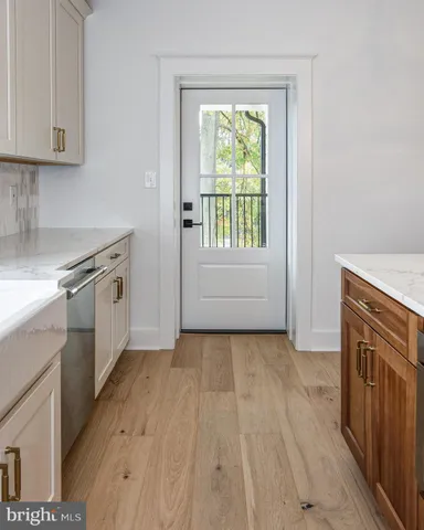 a kitchen with a stove a sink and a window