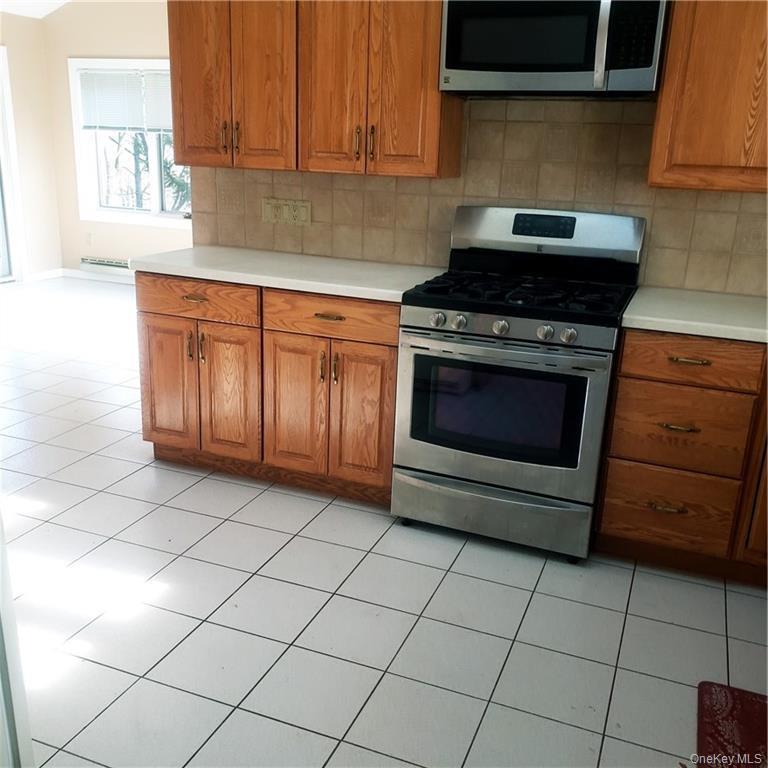179 Old Turnpike Road Woodridge, NY 12789 - Photo 5 of 14 a kitchen with granite countertop white cabinets and appliances
