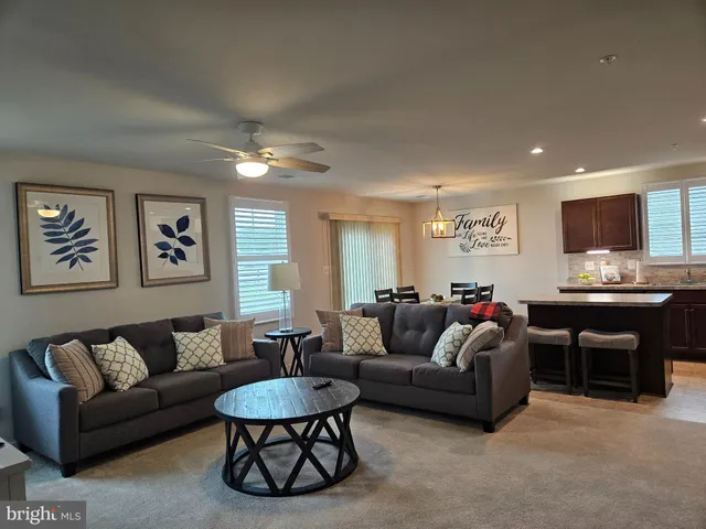a living room with furniture a rug and a window
