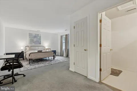 a bedroom with a bed and a chair in it