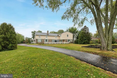 a view of a house with garden and a trees