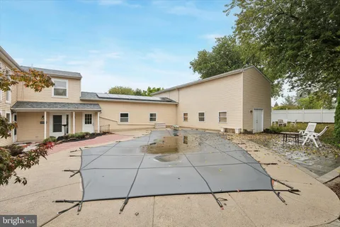a view of a white house with wooden floor and sitting space