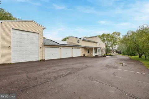 a view of a house with a yard and garage