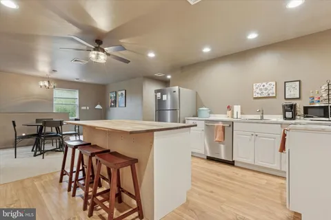a kitchen with appliances cabinets and furniture