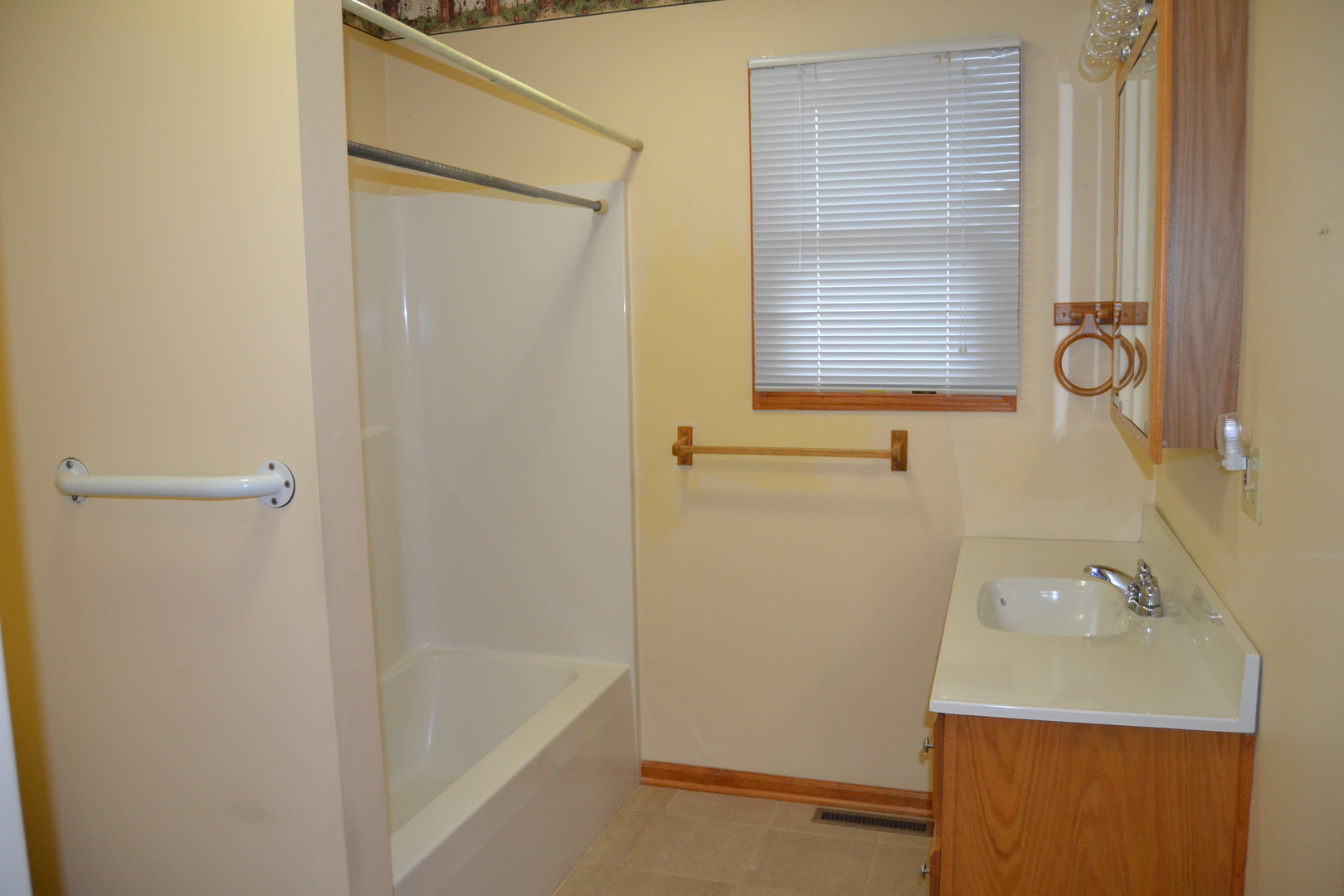 208 Nebraska Street, Unit A Ottawa, IL 61350 - Photo 11 of 14 a bathroom with a sink a bath tub and a window
