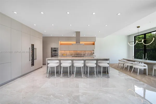 a kitchen with a table and chairs