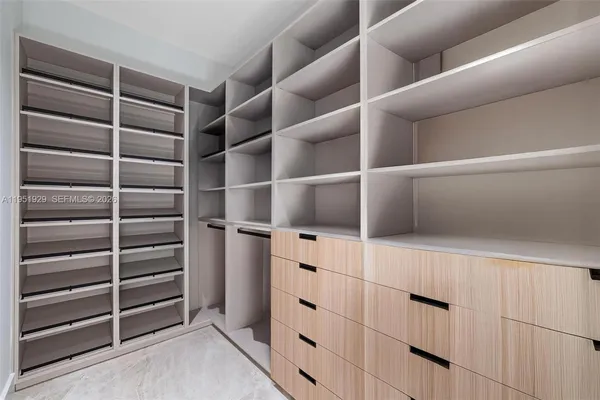 a kitchen with stainless steel appliances granite countertop a sink stove and white cabinets with wooden floor